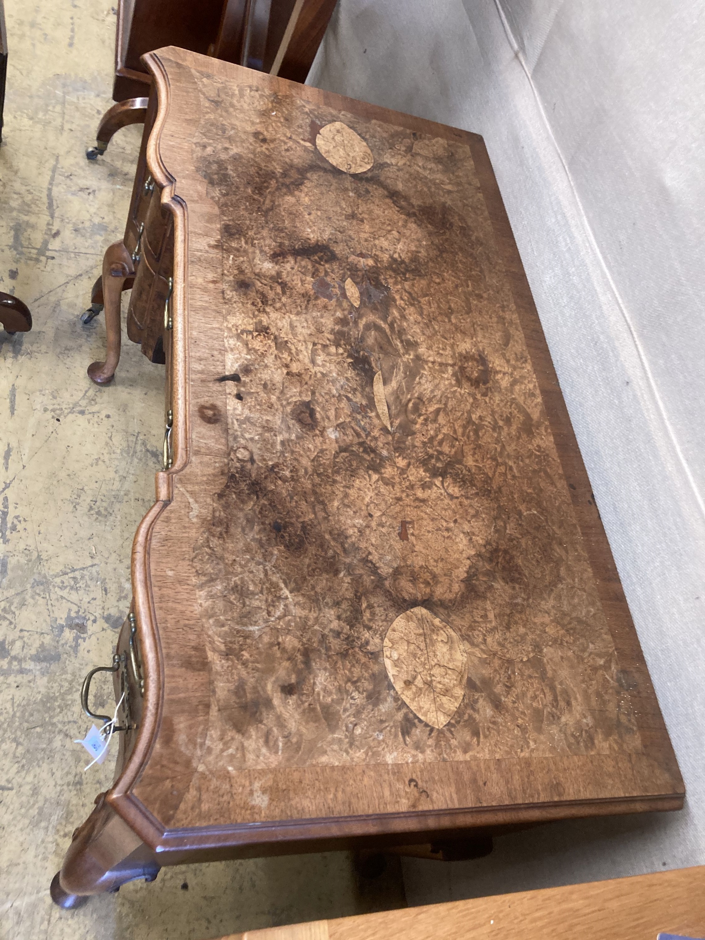 A Queen Anne revival mahogany and walnut breakfront serpentine side table, width 106cm, depth 55cm, height 78cm